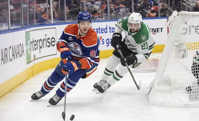 Dallas Stars' Jason Robertson (21) chases Edmonton Oilers' Vasily Podkolzin (92) during the nsecond period of Game 3 of the NHL hockey Stanley Cup Western Conference final in Edmonton, Alberta, Sunday, May 25, 2025. (Jason Franson/The Canadian Press via AP)