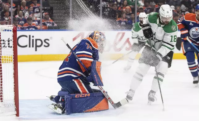 Dallas Stars' Sam Steel (18) sprays Edmonton Oilers goalie Stuart Skinner (74) with ice during the first period of Game 3 of the NHL hockey Stanley Cup Western Conference final in Edmonton, Alberta, Sunday, May 25, 2025. (Jason Franson/The Canadian Press via AP)