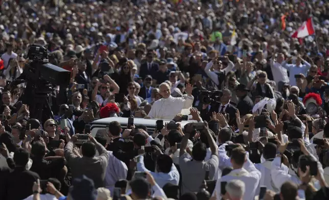 Pope Leo XIV's waves to people before his formal inauguration of his pontificate with a Mass in St. Peter's Square attended by heads of state, royalty and ordinary faithful, Sunday, May 18, 2025. (AP Photo/Alessandra Tarantino)