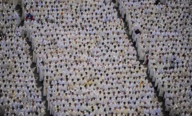 Catholic priests gather as Pope Leo XIV celebrates a Mass for the formal inauguration of his pontificate, in St. Peter's Square, at the Vatican, Sunday, May 18, 2025. (AP Photo/Alessandra Tarantino)