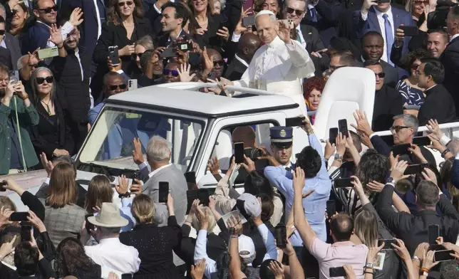 Pope Leo XIV on his popemobile tours St. Peter's Square at the Vatican prior to the inaugural Mass of his pontificate, Sunday, May 18, 2025. (AP Photo/Domenico Stinellis)