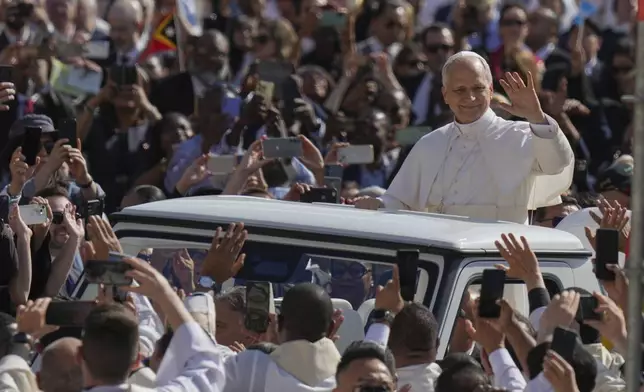 Pope Leo XIV's waves to people before his formal inauguration of his pontificate with a Mass in St. Peter's Square attended by heads of state, royalty and ordinary faithful, Sunday, May 18, 2025. (AP Photo/Alessandra Tarantino)