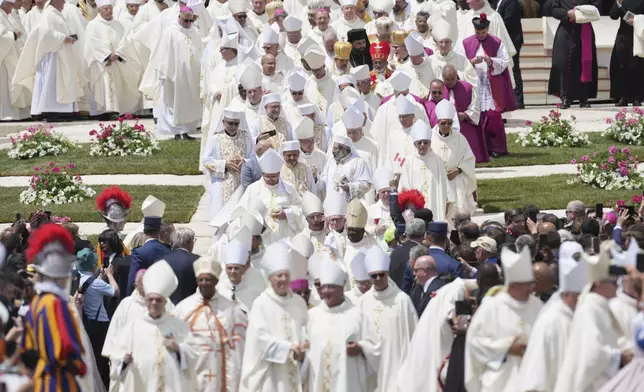 Cardinals and bishops leave after Pope Leo XIV celebrated a Mass for the formal inauguration of his pontificate, in St. Peter's Square, at the Vatican, Sunday, May 18, 2025. (AP Photo/Andrew Medichini)