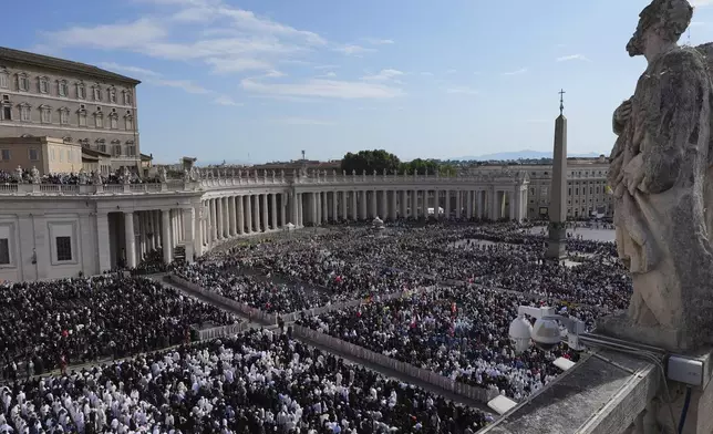 Guests and the faithful attend the inaugural Mass of Pope Leo XIV's pontificate in St. Peter's Square at the Vatican, Sunday, May 18, 2025. (AP Photo/Jacquelyn Martin, Pool)