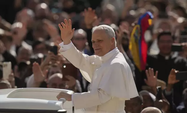 Pope Leo XIV's waves to people before his formal inauguration of his pontificate with a Mass in St. Peter's Square attended by heads of state, royalty and ordinary faithful, Sunday, May 18, 2025. (AP Photo/Alessandra Tarantino)