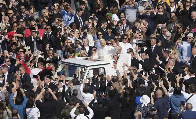 Pope Leo XIV on his popemobile tours St. Peter's Square at the Vatican prior to the inaugural Mass of his pontificate, Sunday, May 18, 2025. (AP Photo/Domenico Stinellis)