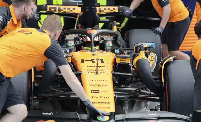 McLaren driver Oscar Piastri of Australia is wheeled in to the garage during the qualifying session for the Formula One Miami Grand Prix auto race at the International Autodrome, Saturday, May 3, 2025, in Miami Gardens, Fla. (Shawn Thew/Pool Photo via AP)