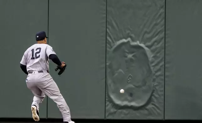 New York Yankees centerfielder Trent Grisham chases down a ball hit off the outfield wall during the fourth inning of a baseball game against the New York Yankees, Tuesday, May 13, 2025, in Seattle. (AP Photo/Stephen Brashear)