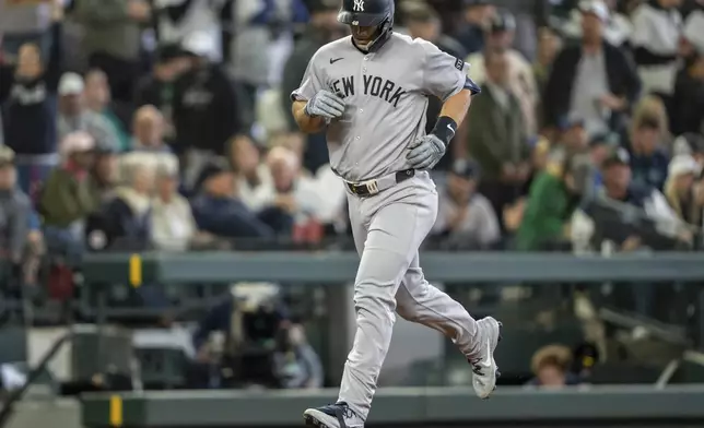 New York Yankees' Paul Goldschmidt rounds the bases after hitting a solo home run during the seventh inning of a baseball game against the Seattle Mariners, Wednesday, May 14, 2025, in Seattle. (AP Photo/Stephen Brashear)
