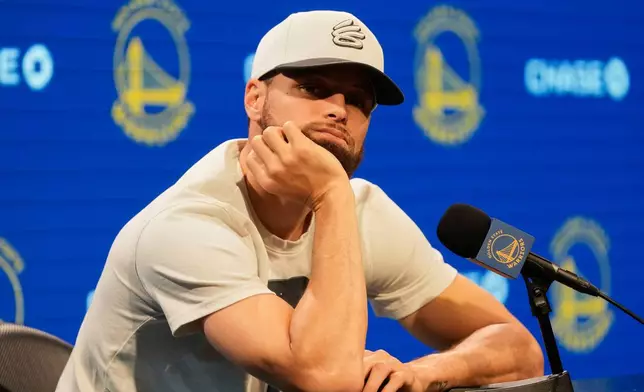 Golden State Warriors guard Stephen Curry listens during a news conference at the NBA basketball team's facility in San Francisco, Thursday, May 15, 2025. (AP Photo/Jeff Chiu)