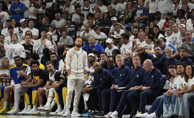 Golden State Warriors guard Stephen Curry (30) looks on near the bench during the second half of Game 5 of an NBA basketball second-round playoff series against the Minnesota Timberwolves, Wednesday, May 14, 2025, in Minneapolis. (AP Photo/Abbie Parr)