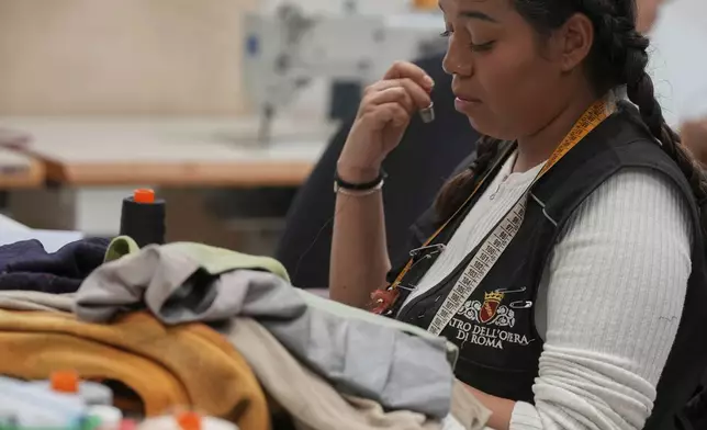 A tailor works on stage costumes in the "Teatro dell' Opera" opera house costumes laboratory, in Rome, Thursday, April 10, 2025. (AP Photo/Andrew Medichini)