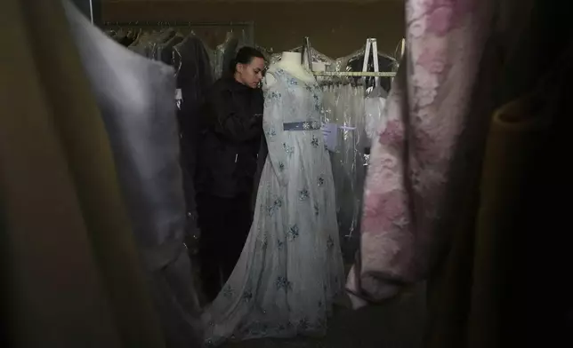 A tailor works on a stage costume for Giacomo Puccini's "Tosca" opera in the "Teatro dell' Opera" opera house costumes warehouse, in Rome, Thursday, April 10, 2025. (AP Photo/Andrew Medichini)