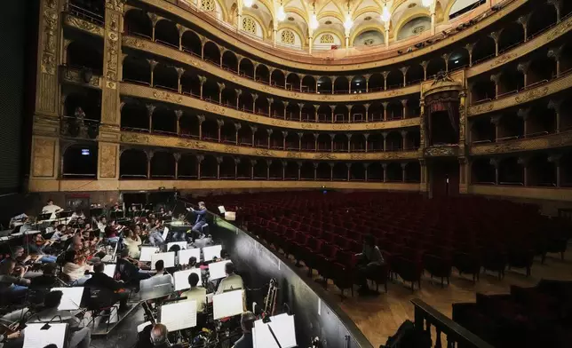Michele Mariotti, right, director of the "Teatro dell' Opera" opera house orchestra, practices in Rome, Thursday, April 10, 2025. (AP Photo/Andrew Medichini)