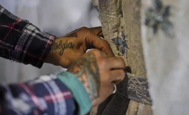 A tailor works on a stage costume for Giacomo Puccini's "Tosca" opera in the "Teatro dell' Opera" opera house costumes warehouse, in Rome, Thursday, April 10, 2025. (AP Photo/Andrew Medichini)