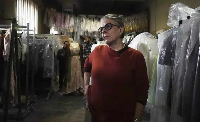 Anna Biagiotti, head of tailoring at the Rome's Teatro dell' Opera" opera house, walks in the house's costumes warehouse, Thursday, April 10, 2025. (AP Photo/Andrew Medichini)