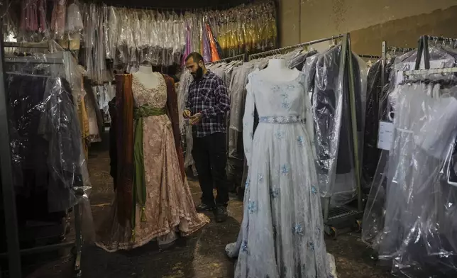 A tailor works on a stage costume for Giacomo Puccini's "Tosca" opera in the "Teatro dell' Opera" opera house costumes warehouse, in Rome, Thursday, April 10, 2025. (AP Photo/Andrew Medichini)