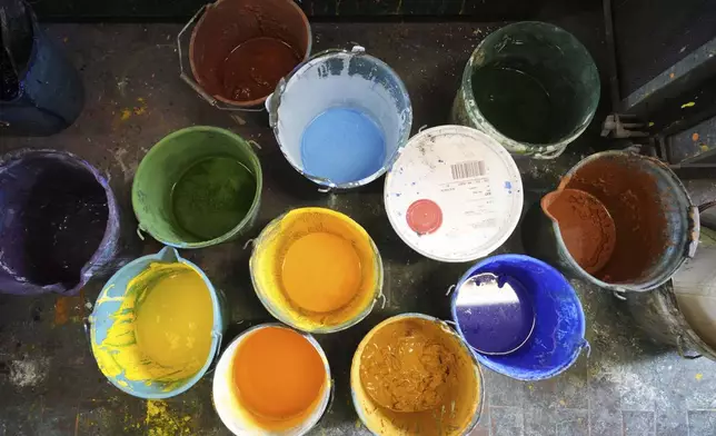 Buckets of paint used for stage canvases are seen in a laboratory of the "Teatro dell' Opera" opera house warehouse, in Rome, Thursday, April 10, 2025. (AP Photo/Andrew Medichini)