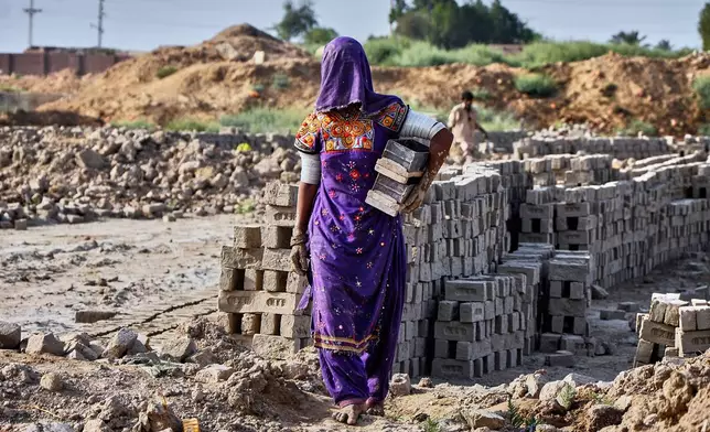 A woman works at a brick kiln during May Day, on the outskirts of Hyderabad, Pakistan, Thursday, May 1, 2025. (AP Photo/Pervez Masih)