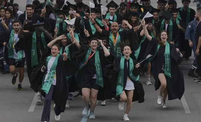 Graduating students runners participate in the 5 kilometers (3.1 miles) Fun Run of Beirut International Marathon in Beirut, Lebanon, Thursday, May 1, 2025. (AP Photo/Bilal Hussein)