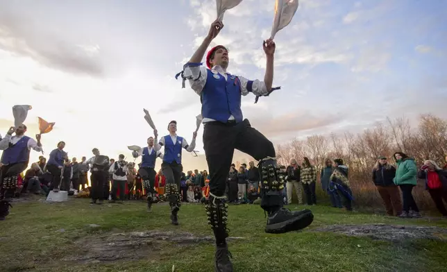 Several groups of Morris dancers gather at Putney Mountain Summit in Putney, Vt., just before sunrise to celebrate May Day on Thursday, May 1, 2025. (Kristopher Radder/The Brattleboro Reformer via AP)