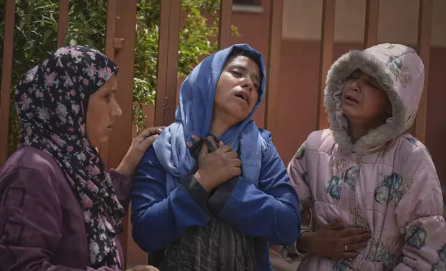Islam Abu Sahloul, center, mourns the death of her sister Lamia, 32, who was killed when an Israeli army strike hit a house killing at least five people, in Khan Younis, in the southern Gaza Strip, Thursday, May 1, 2025. (AP Photo/Abdel Kareem Hana)