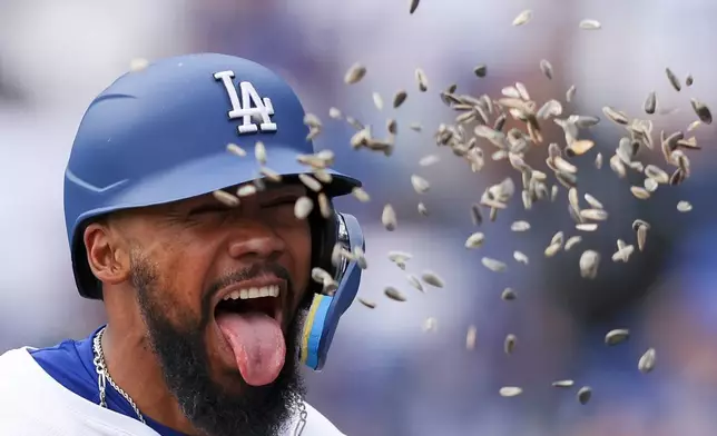 Los Angeles Dodgers' Teoscar Hernández celebrates as sunflower seeds are thrown at him after hitting home run during the fifth inning of a baseball game against the Pittsburgh Pirates in Los Angeles, Sunday, April 27, 2025. (AP Photo/Jessie Alcheh)