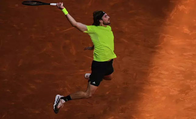 Stefanos Tsitsipas of Greece returns the ball against Lorenzo Musetti of Italy during the Madrid Open round of 32 tennis match in Madrid, Spain, Tuesday, April 29, 2025. (AP Photo/Manu Fernandez)