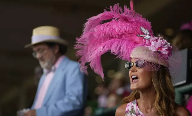A race fan sits in the stands at Churchill Downs before the 151st running of the Kentucky Oaks horse race Friday, May 2, 2025, in Louisville, Ky. (AP Photo/Charlie Riedel)
