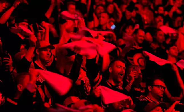 Ottawa Senators fans are bathed in red light as they wave towels before Game 6 of a first-round NHL hockey playoff series against the Toronto Maple Leafs in Ottawa, Ontario, Thursday, May 1, 2025. (Justin Tang/The Canadian Press via AP)