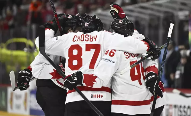 Canada celebrates the 1-1 goal by Travis Konecny, during the IIHF Ice Hockey World Championship group A match between Latvia and Canada at Avicii Arena in Stockholm, Sweden, Sunday May 11, 2025. (Christine Olsson/TT News Agency via AP)