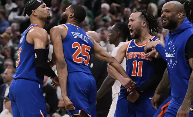 New York Knicks celebrate after defeating the Boston Celtics in Game 1 of an NBA basketball second-round playoff series Monday, May 5, 2025, in Boston. (AP Photo/Charles Krupa)