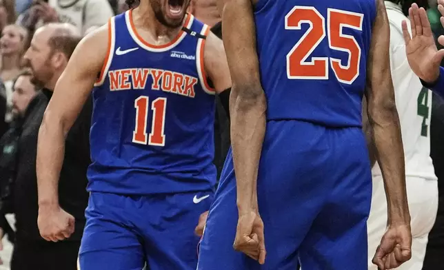 New York Knicks guard Jalen Brunson (11) celebrates with Mikal Bridges (25) after defeating the Boston Celtics in Game 1 of an NBA basketball second-round playoff series Monday, May 5, 2025, in Boston. (AP Photo/Charles Krupa)