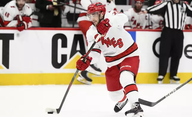 Carolina Hurricanes defenseman Sean Walker (26) takes a shot in the second period of Game 1 of a second-round NHL hockey playoff series against the Washington Capitals Tuesday, May 6, 2025, in Washington. (AP Photo/Nick Wass)