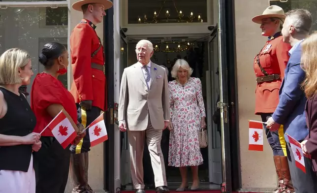 Britain's King Charles, centre left, and Queen Camilla leave after visiting the Canada House Trafalgar Square, in London, Tuesday, May 20, 2025 to mark 100 years since it opened in June 1925. (Arthur Edwards/Pool via AP)