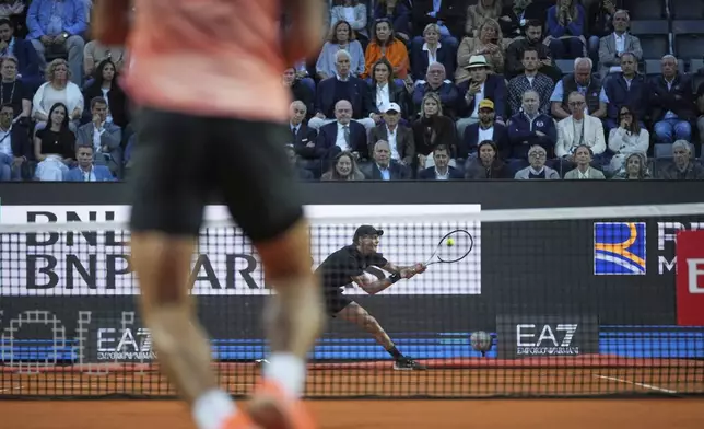 Italy's Jannik Sinner hits a return shot against Argentina's Mariano Navone during a second round match at the Italian Open tennis tournament in Rome, Saturday, May 10, 2025. (AP Photo/Andrew Medichini)