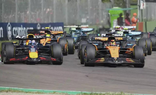 Red Bull driver Max Verstappen of the Netherlands, left, and McLaren driver Oscar Piastri of Australia leadat the start during the Italy's Emilia Romagna Formula One Grand Prix, in Imola, Italy, Sunday, May 18, 2025. (AP Photo/Antonio Calanni)
