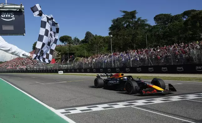 Red Bull driver Max Verstappen of the Netherlands crosses the finish line to win the Italian Emilia Romagna Formula One Grand Prix, at the Enzo and Dino Ferrari racetrack in Imola, Italy, Sunday, May 18, 2025. (AP Photo/Luca Bruno, Pool)