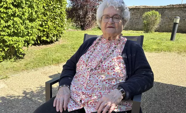 Genevieve Perrier, 99, a civilian under Nazi occupation, poses as she answers the Associated Press on Tuesday April 29 2025 in Precy sous Thil, Burgundy, France. (AP Photo/Nicolas Garriga)