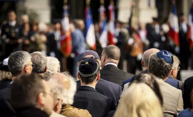 People attend the ceremony marking the 80th anniversary of the return of the deportees, in Paris, France, Sunday, April 27, 2025. (AP Photo/Thomas Padilla)