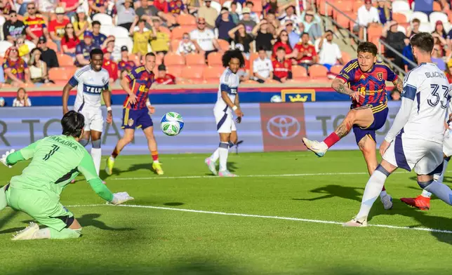 Real Salt Lake midfielder Diego Luna, second from right, shoots and scores against Vancouver Whitecaps goalkeeper Yohei Takaoka (1) during the first half of an MLS soccer match Saturday, May 24, 2025, in Sandy, Utah. (AP Photo/Tyler Tate)