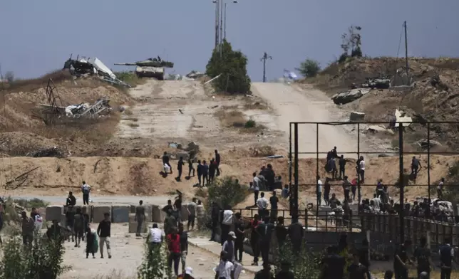 Israeli tanks taking position next to an humanitarian aid packages distribution center delivered by the Gaza Humanitarian Foundation, a U.S.-backed organization approved by Israel, in Khan Younis, southern Gaza Strip, on Thursday, May 29, 2025. (AP Photo/Abdel Kareem Hana)