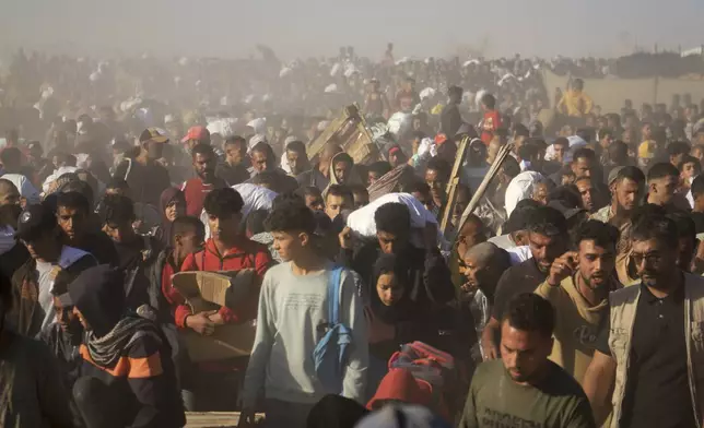 Palestinians carry boxes and bags containing food and humanitarian aid packages delivered by the Gaza Humanitarian Foundation, a U.S.-backed organization approved by Israel, in Rafah, southern Gaza Strip, Thursday, May 29, 2025.(AP Photo/Mariam Dagga)