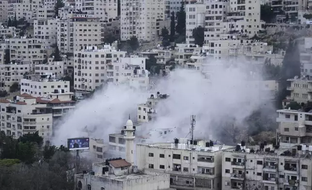 Smoke rises as the Israeli forces demolish the home of Jaafar Mona, a Palestinian militant who died when the bomb he was carrying in Tel Aviv exploded, apparently prematurely, last August. In the West Bank City of Nablus on Thursday, May 29, 2025. (AP Photo/Majdi Mohammed)
