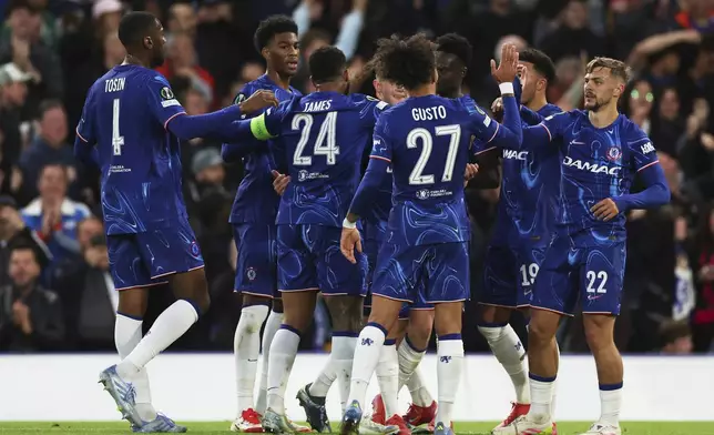 Chelsea's Kiernan Dewsbury-Hall celebrates with teammates after scoring his side's opening goal during the Europa Conference League semifinal second leg soccer match between Chelsea and Djurgarden, at Stamford Bridge stadium in London, Thursday, May 8, 2025. (AP Photo/Ian Walton)