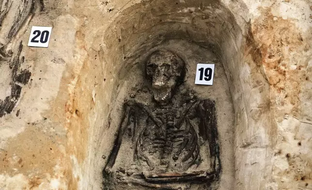 The remains of a German WWII soldiers are exhume in Ostrołęka, Poland, Wednesday, March 19, 2025. (AP Photo/Czarek Sokolowski)
