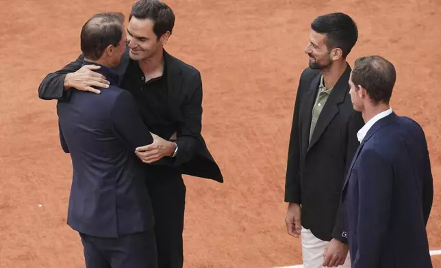 Rafa Nadal, left, hugs Roger Federer, as Novak Djokovic and Andy Murray, right, look on, during a farewell ceremony at center court Philippe-Chatrier, at the Roland-Garros stadium, in Paris, Sunday May 25, 2025.