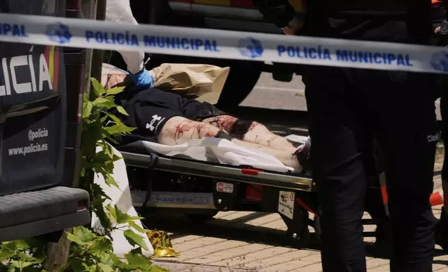 A view of the scene after Andrii Portnov, an adviser to former Ukrainian president Viktor Yanukovych, was shot, outside a school in Madrid, Spain, Wednesday, May 21, 2025. (AP Photo/Paul White)