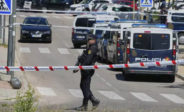 Police officers cordon off the area after an adviser to former Ukrainian president Viktor Yanukovych was shot, outside a school in Madrid, Spain, Wednesday, May 21, 2025. (AP Photo/Paul White)