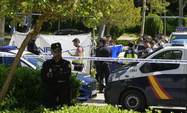 Members of the judicial police at the scene after an adviser to former Ukrainian president Viktor Yanukovych was shot, outside a school in Madrid, Spain, Wednesday, May 21, 2025. (AP Photo/Paul White)